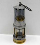 A miners lamp with brass plaque "The Bifold Burner