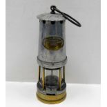 A miners lamp with brass plaque "The Bifold Burner