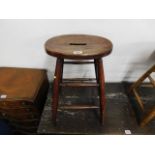 An antique elm seated stool 24in high