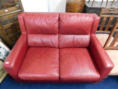 An Italian leather red two seater leather sofa