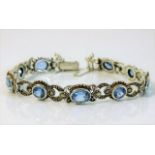 A silver bracelet set with marcasite & blue stone