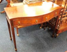 A serpentine fronted two drawer mahogany hall tabl