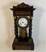 An inlaid French portico clock with twist pillars,