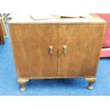 A small footed two door cupboard 33in wide x 31in