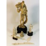 An Oriental resin figure twinned with two ivory fi