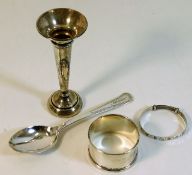 A silver posy vase twinned with a silver spoon ins