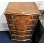 A five drawer serpentine fronted chest of drawers