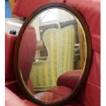A mahogany framed oval mirror 27.75in high x 19.75