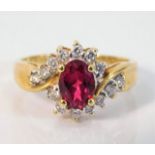 An 18ct gold ring set with 0.25ct diamond & red st