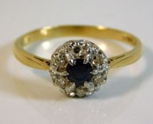 An 18ct gold ring set with diamond & sapphire with