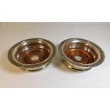 Two antique silver plated wine coasters