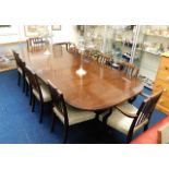 A large mahogany dining table with ten upholstered