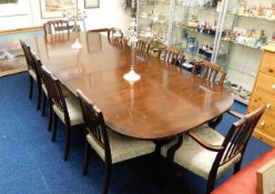 A large mahogany dining table with ten upholstered