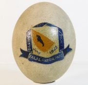 A hand painted penguin egg with the motto: The Des
