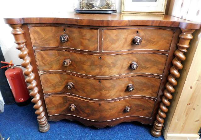 A Victorian serpentine front chest of five drawers