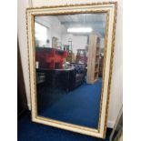 A large antique mirror with painted & gilded frame