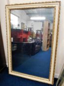 A large antique mirror with painted & gilded frame