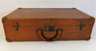 An antique Louis Vuitton leather suitcase