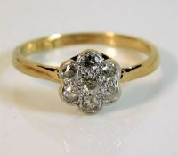 An 18ct gold daisy ring with platinum mounted diam