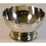A silver sugar bowl with decorative edging by Aitk