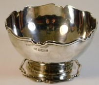 A silver sugar bowl with decorative edging by Aitk