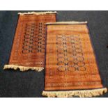 A pair of fringed silk style rugs 58in long x 40in