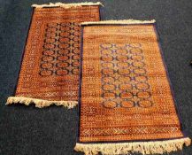 A pair of fringed silk style rugs 58in long x 40in