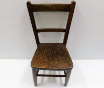 An antique elm childs chair 24in high to back