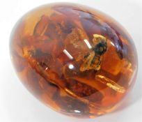 A polished amber egg with bug 69.8g 56mm high £30-