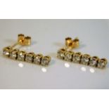 A pair of 18ct gold drop earrings of 1ct diamonds