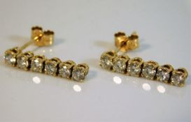 A pair of 18ct gold drop earrings of 1ct diamonds