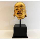 An antiquated Chinese gilded stoneware head mounte