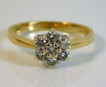 An 18ct gold daisy ring set with approx. 0.5ct dia