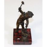 A small antique bronze of cherub working with anvi