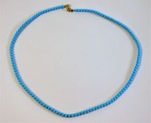 A natural turquoise necklace set with 18ct gold cl