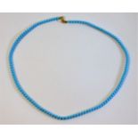 A natural turquoise necklace set with 18ct gold cl