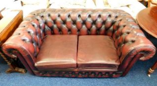A two seater oxblood red Chesterfield style sofa 6