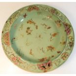 A large possibly 18thC. Oriental celadon style charger 15.25in diameter with painted moths & foliate