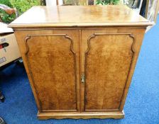 A walnut entertainments cabinet