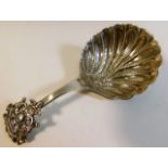 An ornate scalloped edge Dutch silver caddy spoon