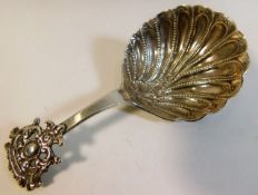 An ornate scalloped edge Dutch silver caddy spoon