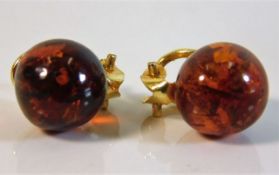 A pair of gilt mounted clip on amber earrings £20-