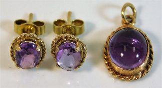 A pair of 9ct gold mounted amethyst earrings twinn