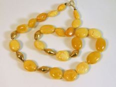 An 18ct gold clasped with 18ct gold beads (tested) amber bead set 19in long 28.7g