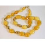 An 18ct gold clasped with 18ct gold beads (tested) amber bead set 19in long 28.7g