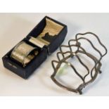 A silver toast rack a/f twinned with a cased silve