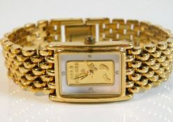 A gold plated wristwatch with Footprints motto to