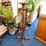An antique mahogany torchere 50in high