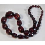 A set of faceted cherry amber style beads approx.