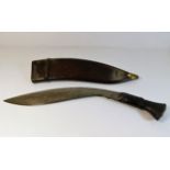 A Gurkha Kukri dagger with leather scabbard dated